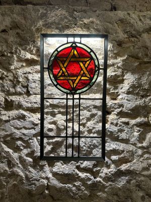 a stained glass window with a star of david on it