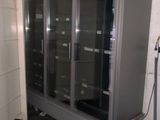 an image of a refrigerator in a room with a lot of boxes