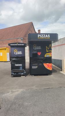 two vending machines in a parking lot next to a building