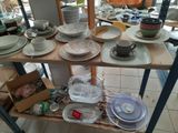 many plates and bowls on a shelf in a room