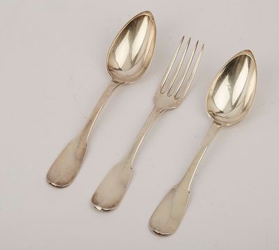 three silver spoons and a fork on a white surface