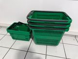 two green baskets sitting on the floor next to each other