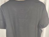 a grey shirt hanging on a hanger in front of a white curtain