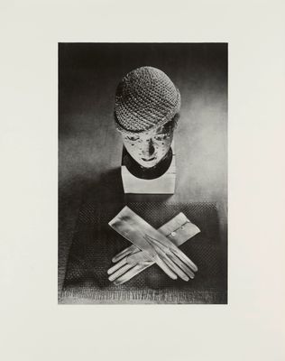 black and white photograph of a mannequin with gloves and a hat