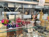 a glass display case with many different glass items in it
