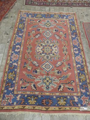 rugs and rugs on the floor in a room with tile flooring