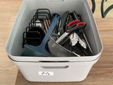 a white container with scissors and other office supplies in it