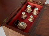 a wooden box that has a set of perfume bottles in it