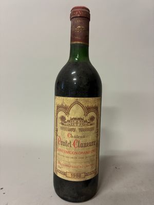 an old bottle of wine sitting on top of a table