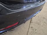 a close up of a car ' s bumper with a dent in it