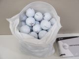 a bag of golf balls sitting on a table next to a package of golf balls