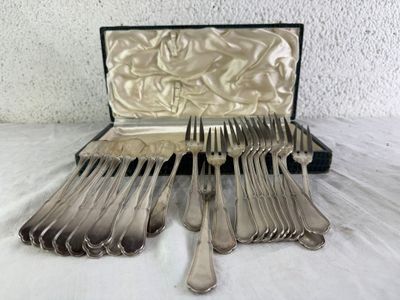 a lot of silverware in a case on a table