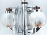 a chandelier with three glass globes hanging from the ceiling