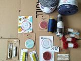 a box with a bunch of sewing supplies sitting on top of it