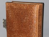 a small brown book with a lock on it