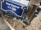 a close up of a small blue tractor with a trailer attached to it