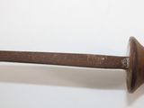 an old iron pipe with a wooden handle on a white surface