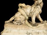 a marble statue of a dog and a cat on a pedestal