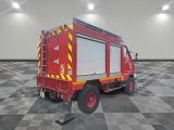 a red fire truck parked in a room with a checkered floor