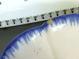 a blue and white bowl sitting on top of a table