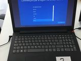 a laptop that is sitting on a desk with a blue screen