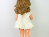 a small doll that is standing on a white surface
