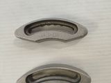two pieces of metal that are on a table