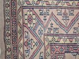 an old rug with a design on it is laying on the floor