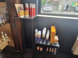 many bottles of hair products on a shelf in a store