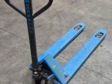 a blue pallet sitting on the floor in a warehouse
