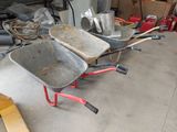 two wheelbarrows that are sitting in a garage