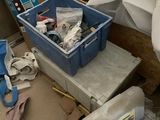 a pile of trash on the floor next to a trash can