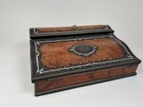 an old wooden box with a black and brown design on it