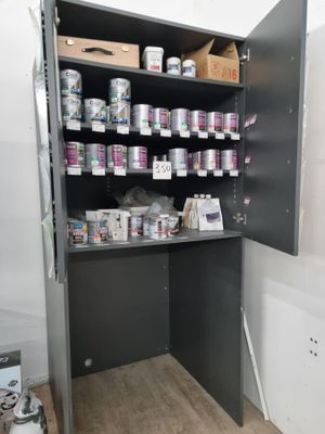 une armoire sur laquelle sont posées de nombreuses boîtes de peinture