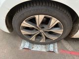 a white car with a flat tire on the street