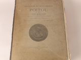 an old book with a coin on top of it sitting on a table