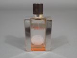an image of a bottle of perfume sitting on top of a table