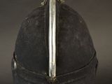 a close up of a helmet on a stand on a black background