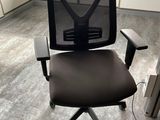 a black office chair in an office cubicle