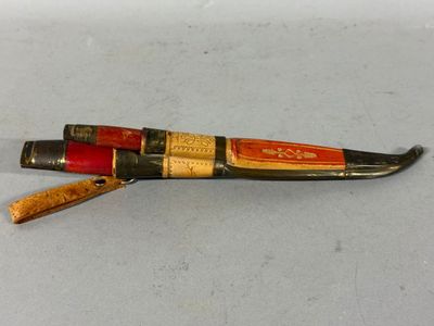 an old knife with a wooden handle on a white surface