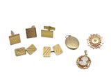 several different types of gold jewelry on a white surface