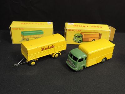 three toy trucks are sitting next to each other on a black surface