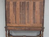 an old wooden cabinet on wheels in a room