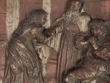 a bronze relief of a man and a woman in a room