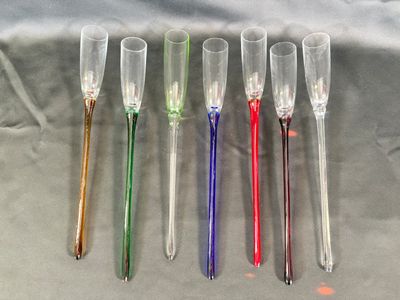 four different colored plastic spoons sitting next to each other on top of a table