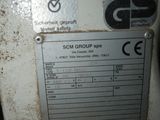 a sign on the side of a machine that says scm group