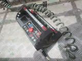 a metal table with a bunch of wires and a remote control