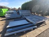 several pieces of metal are stacked on top of each other in a parking lot