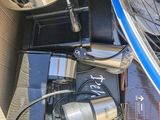a box with a bike, a coffee pot, a kettle, a coffee pot, and other items in it