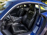 the interior of a blue sports car with its doors open